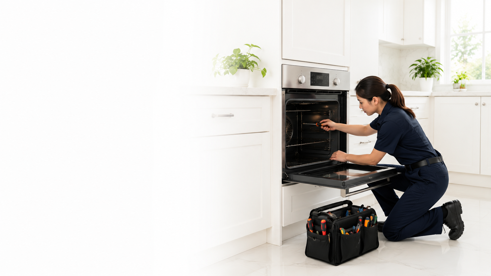 Technician repairing a wall oven